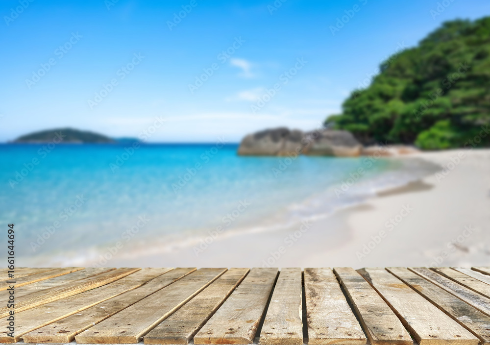 Fototapeta premium Wooden table top on the beach or sea.Party on the beach sunshine time concept.For montage product display or design key visual layout.View of copy space.