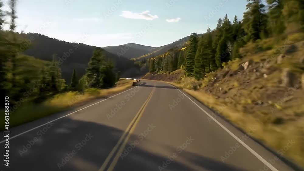 A scenic mountain road winds through a lush forest under a clear blue sky. A scenic mountain road winds through a lush forest under a clear blue sky.