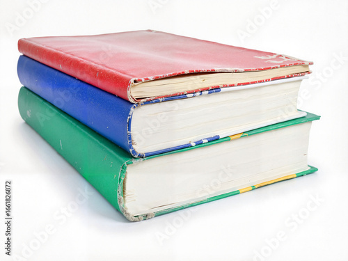Colorful stacked books with worn covers on white background  