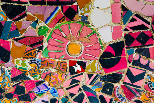 Mosaic of broken tiles in the Parc Guell in Barcelona  The Parc Guell was designed by Antonio Gaudi and is declared as a World Heritage Site by the UNESCO.