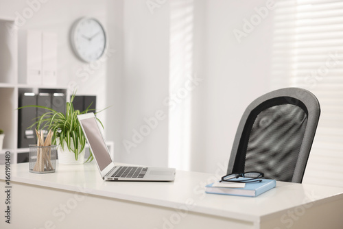 Wallpaper Mural Stylish workplace with laptop, stationery and floral decor on white table in office Torontodigital.ca