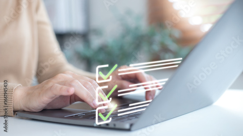 Business person typing on laptop with checklist icons, symbolizing task management, productivity, project planning, and to-do list concept for modern work and business efficiency.