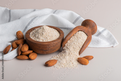 Almonds and almond flour in bowl on table. Almond flour high in protein.