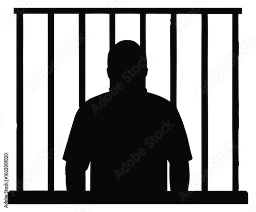 Silhouette of a man standing behind bars depicting confinement and loss of freedom behind jail