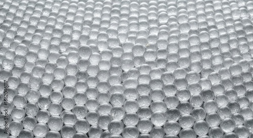 Infinite expanse of transparent spheres creating an abstract textured plane
