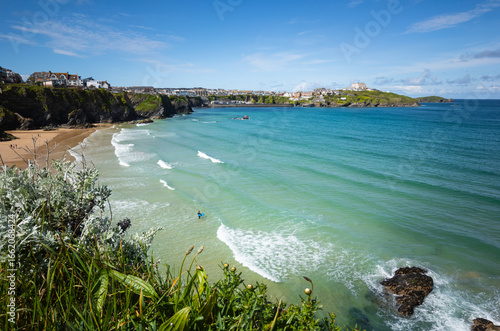 Newquay Great Western Beach Cornwall England with surfer in the sea