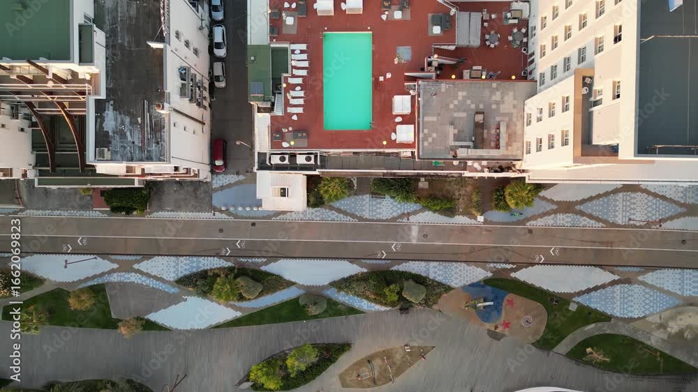 Aerial View of City Landscape: An extraordinary bird's-eye view, capturing the intricate mosaic of urban living, with a striking perspective of buildings, a pool, and pathways. Aerial View of City Landscape: An extraordinary bird's-eye view, capturing the intricate mosaic of urban living, with a striking perspective of buildings, a pool, and pathways.