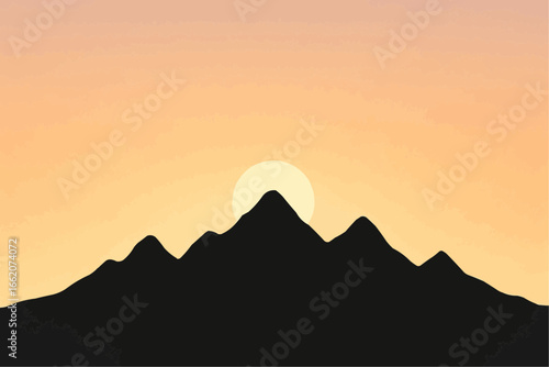 Orange evening sun silhouettes the tranquil mountain landscape