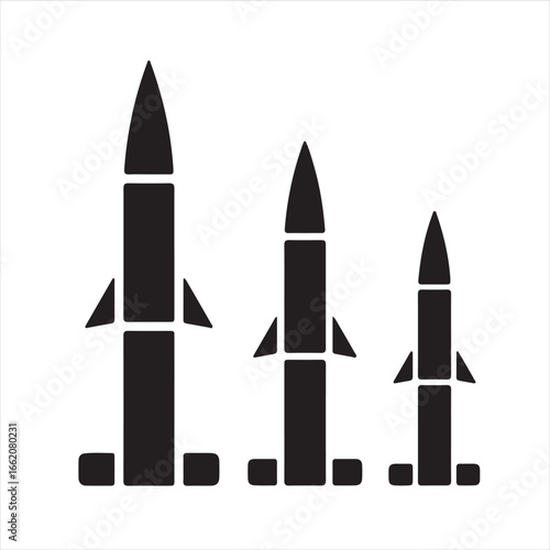 Black silhouettes of three different sized missiles on white background
