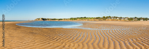 Guidel morbihan clohars carnoet finistere Low Tide Beach with Sand Ripples Under Clear Blue Sky