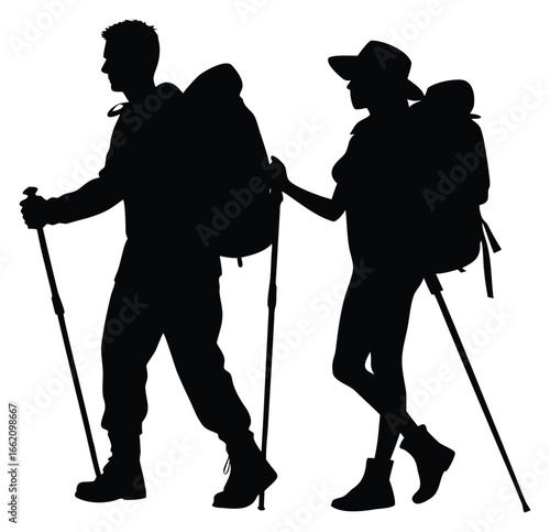 Silhouette of hiking couple with backpacks and walking sticks trekking together