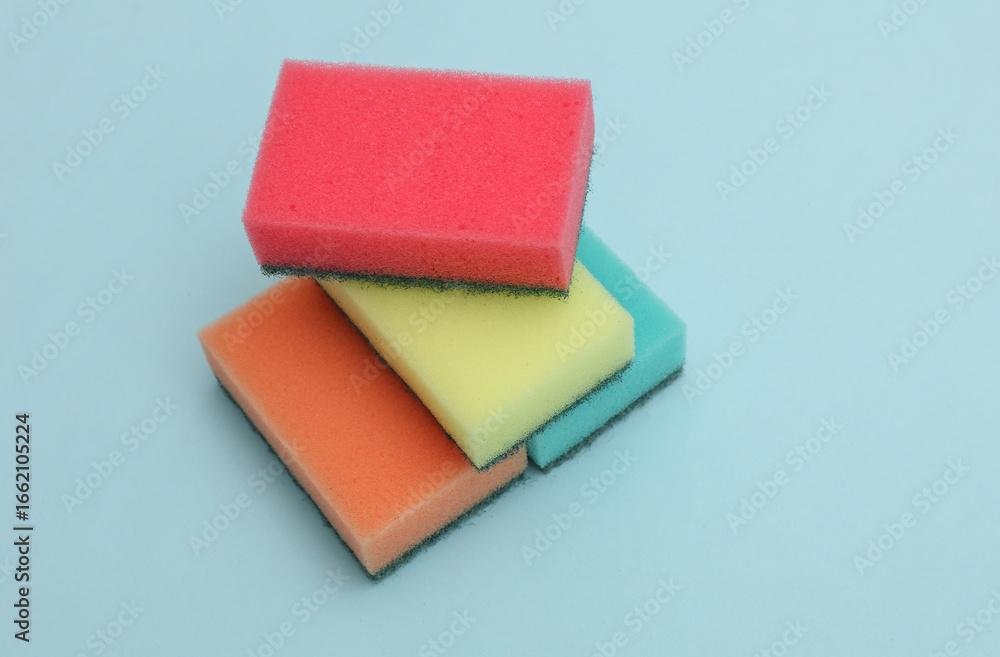 Fototapeta premium Set of colored cleaning sponges on a blue background