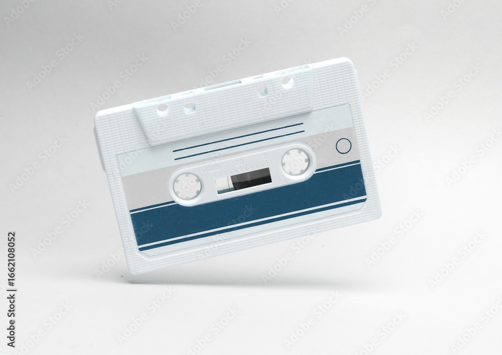 Fototapeta premium Retro audio cassette levitating on white background. Minimalism