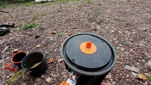 Wallpaper Mural A vibrant camping scene with a pot boiling water over a reliable heat source, perfect for outdoor cooking fans who value practicality and efficiency while appreciating natures beauty Torontodigital.ca