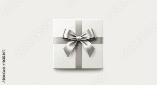 Elegant white square gift box wrapped with a lustrous silver satin ribbon and a perfectly tied bow seen from a topdown view.