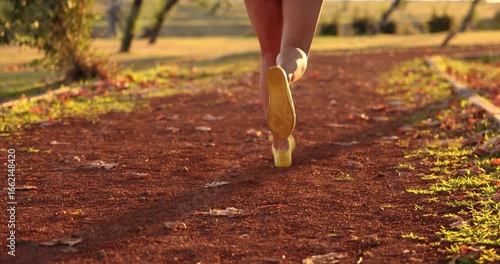 Fit sportswoman working out. Happy young woman outdoors in autumn park. Slow motion. 