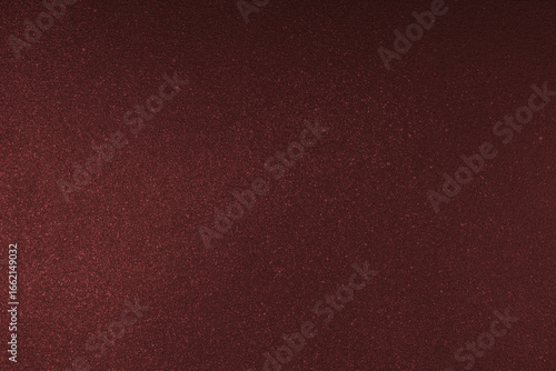 Abstract shiny, radiant texture background with different shades of dark red color. Painted canvas, glitter concrete surface, studio backdrop, grainy textured effect