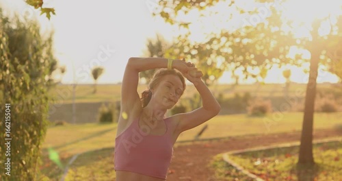 Fit sportswoman working out. Happy young woman outdoors in autumn park. Slow motion. 
