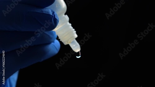 Doctor in blue gloves holds a bottle of eye drops.
Treatment of poor grain and dry eyes.
Dry eyes from sitting at a laptop for a long time.
Ophthalmology concept