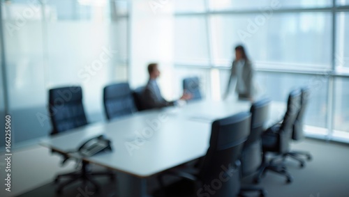 A Blurred Meeting in a Modern Office Space Highlighting Collaboration Between Two Business Professionals