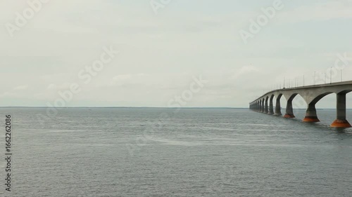 Confederation bridge stretching across the ocean on a cloudy day in canada