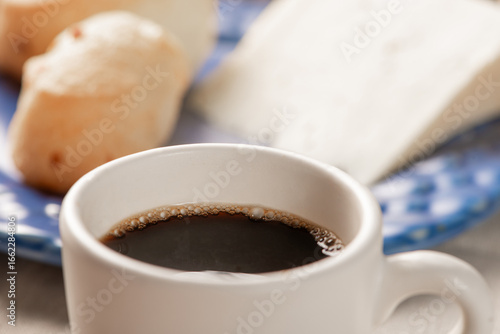 Cheese bread, table with coffee cheese bread and semi-cured cheese from Brazil, selective focus.