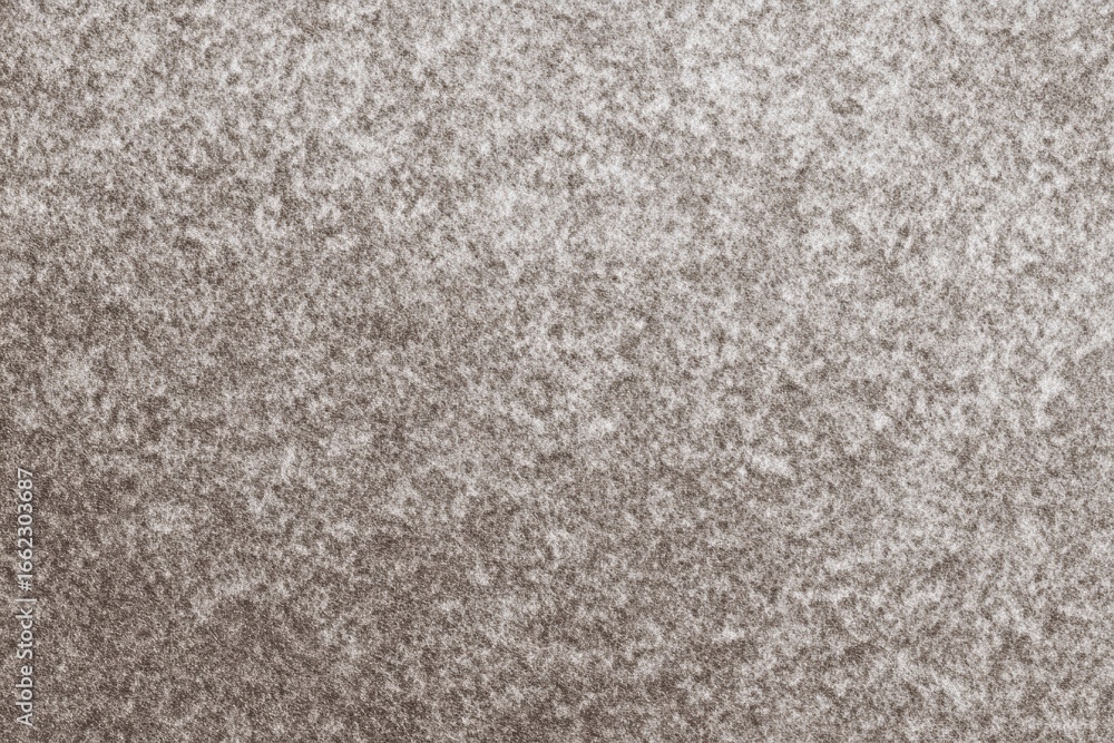 Fototapeta premium Textured close-up of gray and white snowy surface pattern