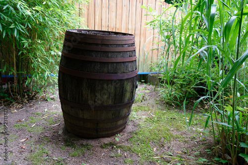 Wallpaper Mural Large wooden barrel with metal hoops near bamboo and fence Torontodigital.ca