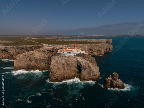 Drone view of Cape St. Vincent lighthouse and rugged cliffs, Sagres, Algarve, Portugal