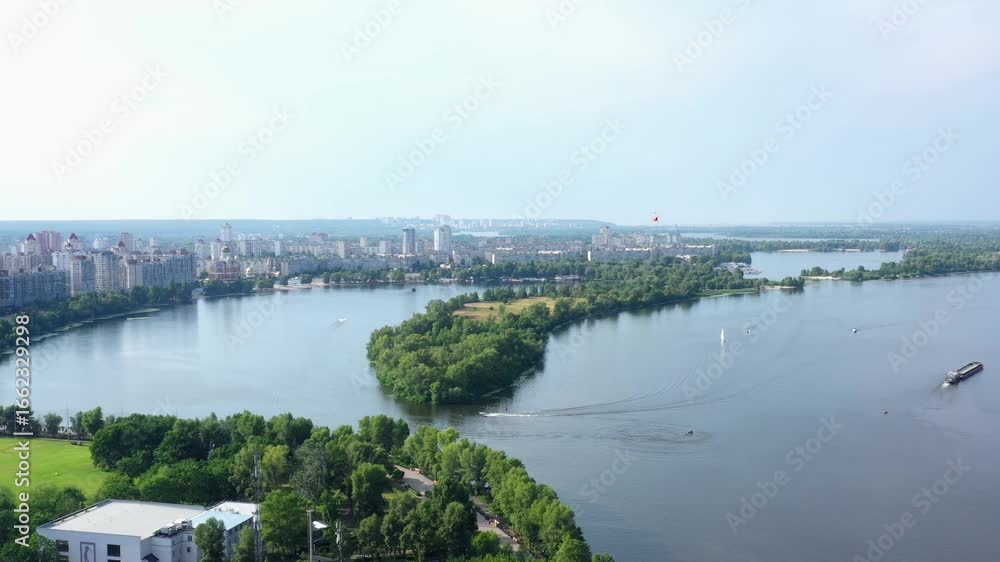 Orange chopper flies over the Dnieper river in Kiev. View from the drone. Orange chopper flies over the Dnieper river in Kiev. View from the drone.