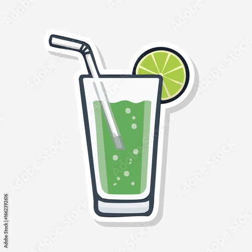 Refreshing green beverage in a tall glass with a straw and lime slice for a cool drink.