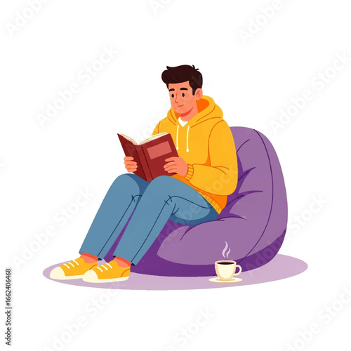 A young man enjoys a peaceful moment, engrossed in reading a book while comfortably seated in a beanbag chair with a warm beverage nearby.