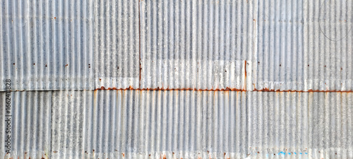 Old zinc vintage fence wall texture for background, pattern of rusty on metal panel.Tin Roof wall countryside
