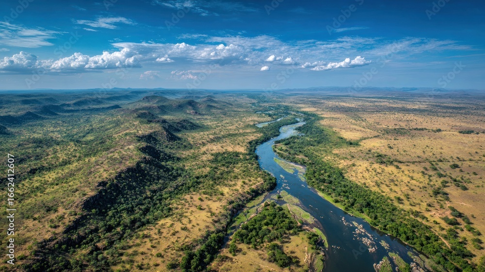 Naklejka premium Aerial view of a meandering river through arid African terrain under a bright blue sky