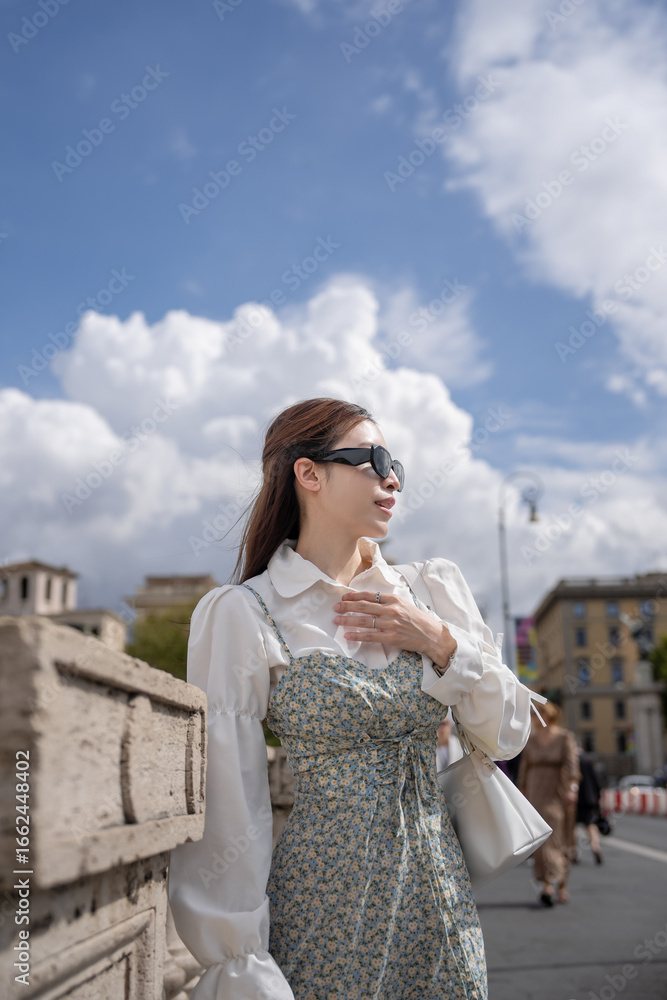 Fototapeta premium Woman posing on a Ponte Vittorio Emanuele II bridge. Rome, Italy.