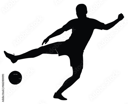 Silhouette of a soccer player kicking a ball in dynamic action shot