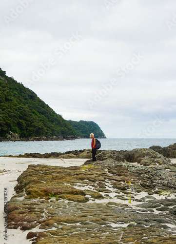 A woman walks around Smugglers Bay, Whangārei Heads, New Zealand.
