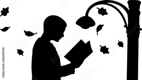 Silhouette of a person reading a book under a street lamp with falling leaves in a black and white image