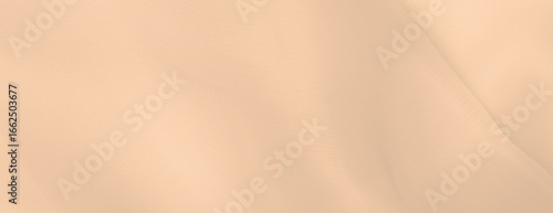 Soft beige background with a smooth texture. The beige background creates a calm and neutral atmosphere, ideal for minimalist designs. Minimal abstract flow line vector gradient background