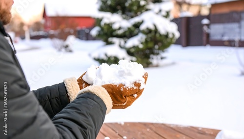 Man holding snow in winter garden