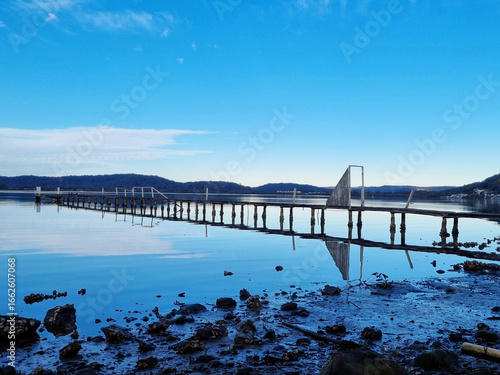 Derelict fishing jetty at Kincumber on the NSW Central Coast. with beautiful reflections. Taken on the Kincumber to Davistown Walk, New South Wales, Australia.