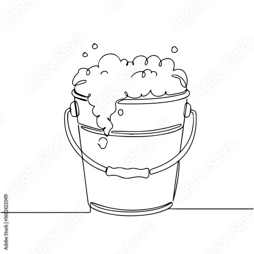 Bucket overflowing with foamy suds.