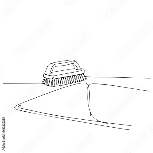 A hand-drawn image shows a brush on a surface.