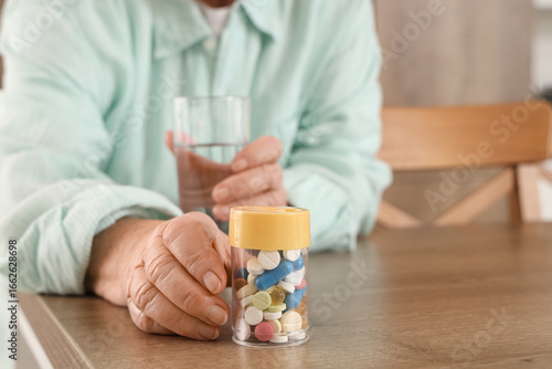 Senior woman with glass of ...