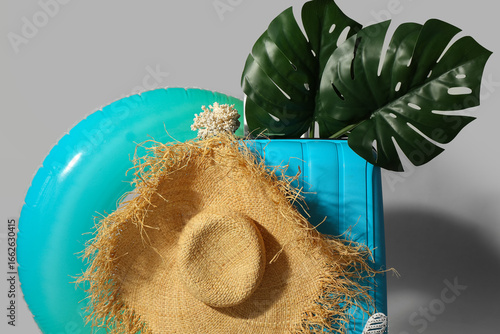 Blue suitcase with beach ac...