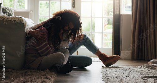 Sad, child and mother with comfort in home for mental health support, mourning and grieving loss. Single parent, woman and hug girl with depression for empathy, compassion and understanding of pain