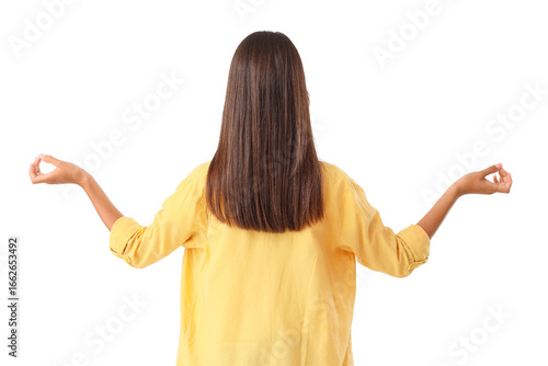 Young woman meditating on white background, back view