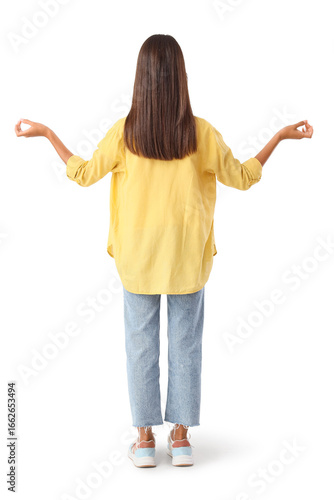 Young woman meditating on w...
