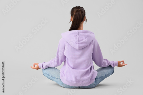 Young woman meditating on l...