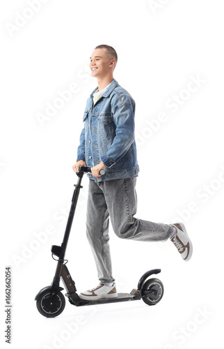 Teenage boy riding electric...
